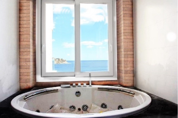 One of the stylish bathrooms with views to the sea