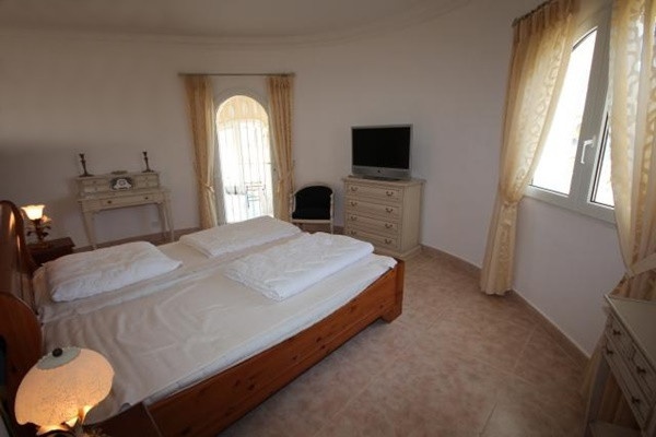 One of the elegant bedrooms with huge windows and direct access to the terrace