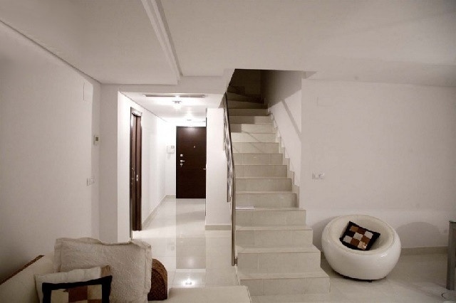 The exquisite living room with stairs that lead to the upper floor