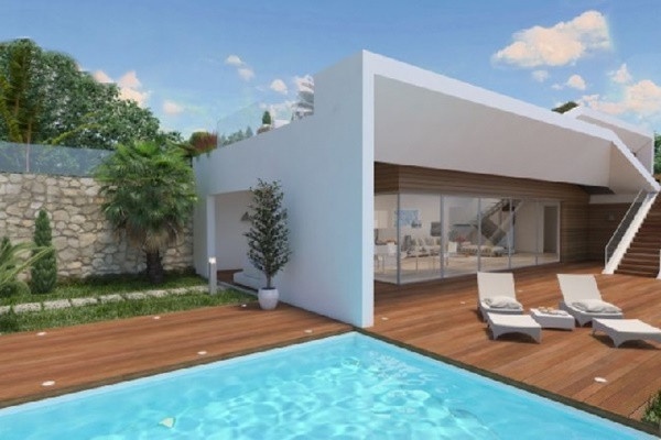The paradise-like outdoor-area of the villa with spacious pool and lots of spaces to relax