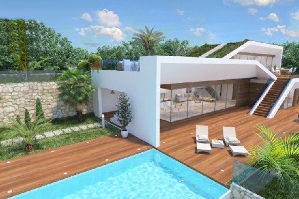 The paradise-like outdoor-area of the villa with spacious pool and lots of spaces to relax 