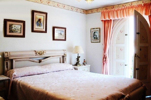 One of the elegant bedrooms with direct access to the balcony