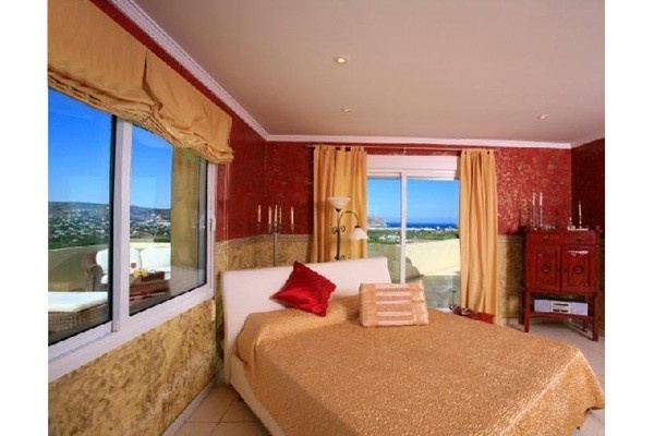 One of the luxurious bedroom with huge windows, which offer incredible views to the sea