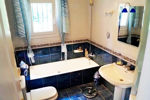 One of the elegant bathrooms with large window