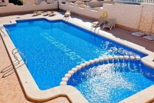 Spacious pool area with sunbeds